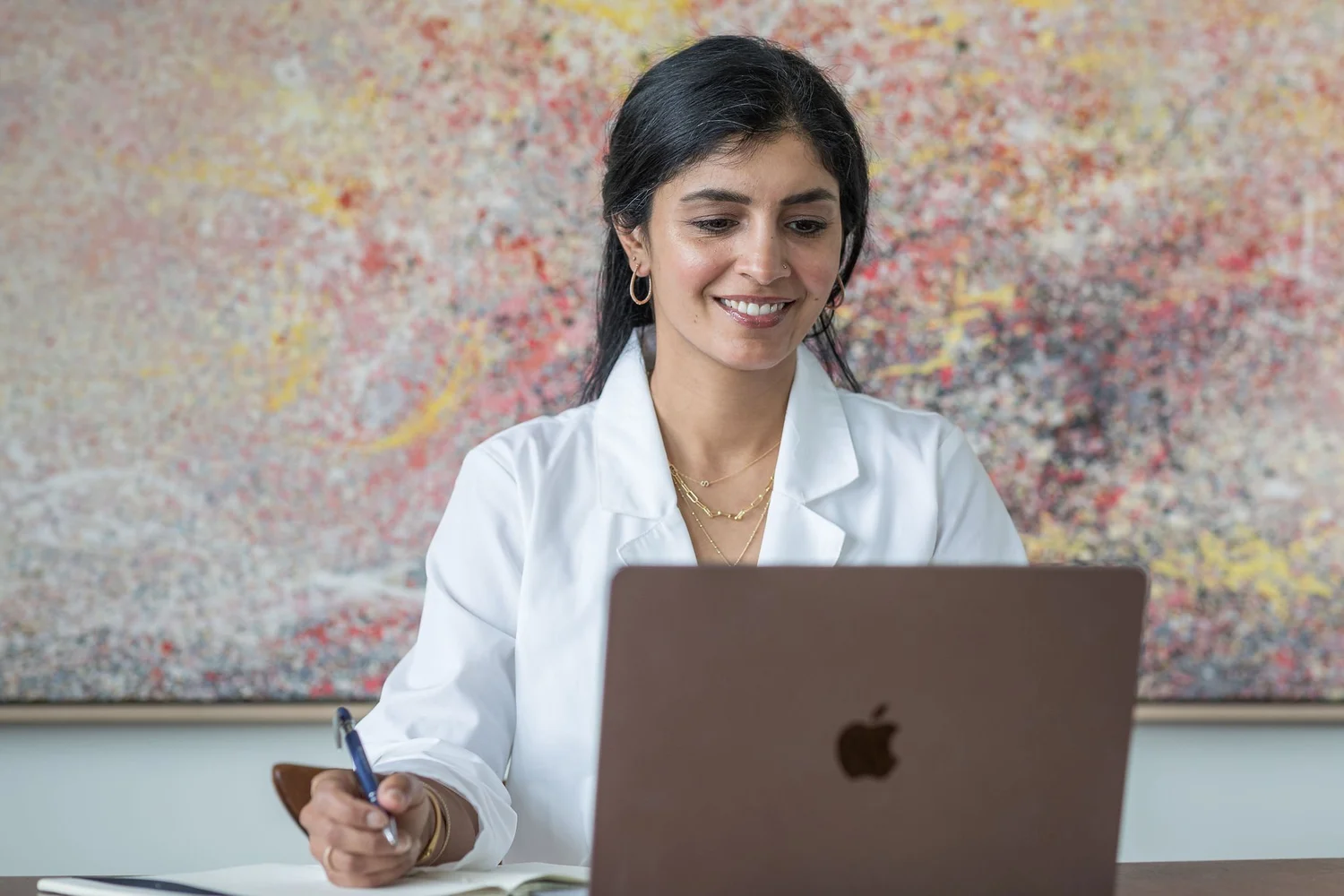 Dr. Raveena Rihal reviewing a lab report at her desk